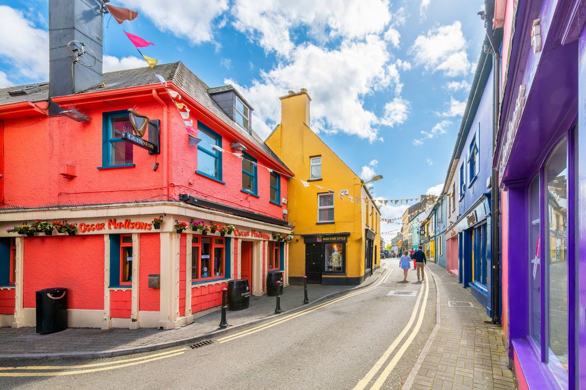Main Street, the central road through the historic old town district of the seaside village of Kinsale, known for its brightly painted shops