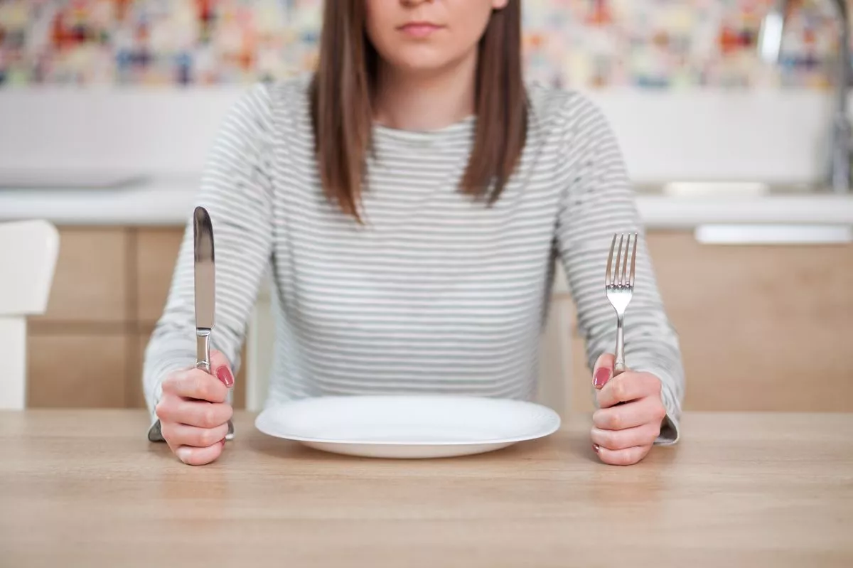 You may not notice a symptom of the flu until you sit down at dinnertime (stock image)