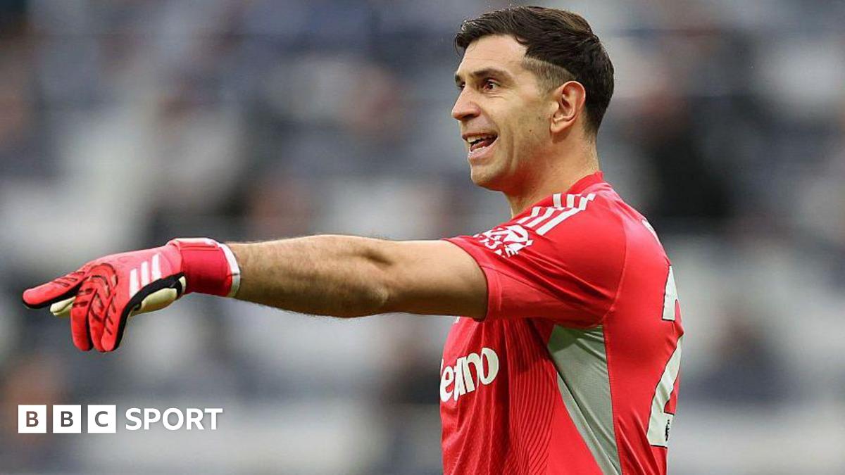 Emiliano Martinez holds out his arm