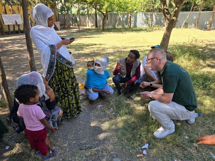 Wicklow filmmaker Mark O'Toole, with mothers at an intake facility for food aid in Tigray, Ethiopia.