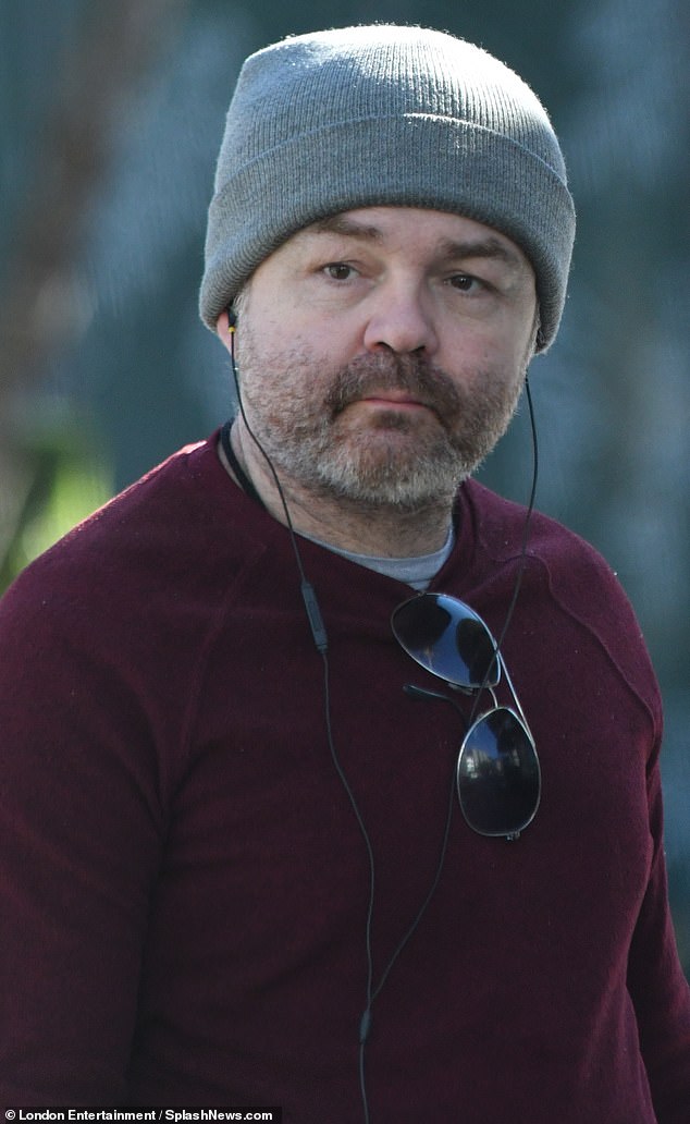 The actor was lightly bundled up in a grey beanie and burgundy sweater