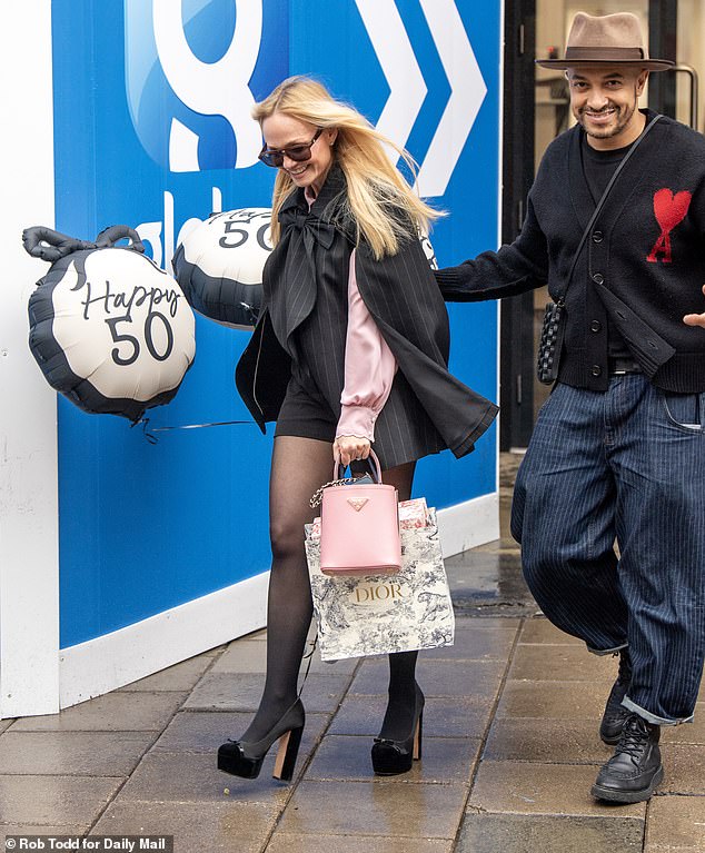 Snaps show the eternally youthful star boasting a big smile as she left Global HQ in Leicester Square whilst holding a gigantic balloon that read 'Happy 50th'