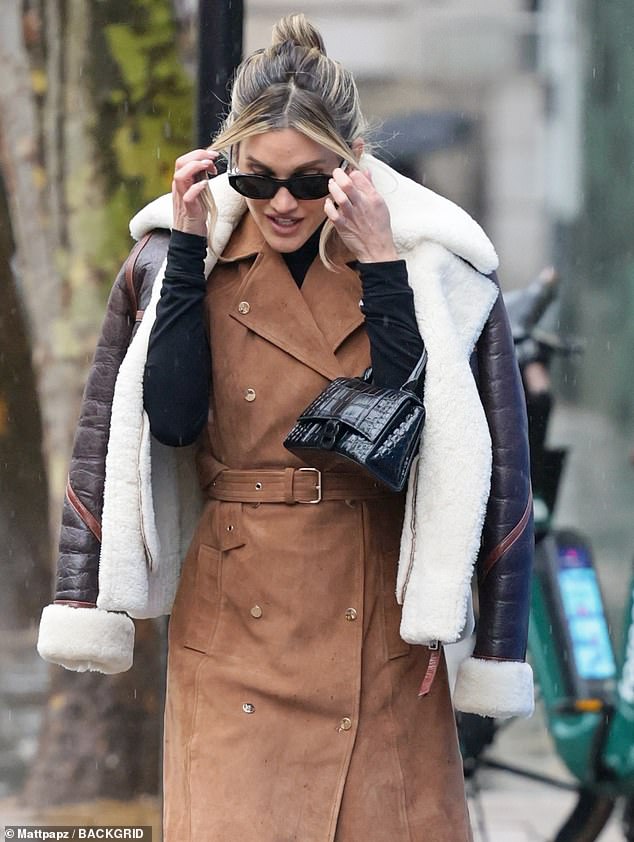 The former Pussycat Dolls singer looked stylish in a suede dress and a brown oversized jacket