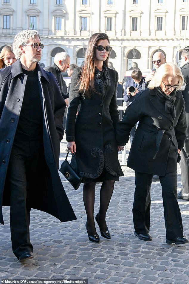 Anne, 43, wore a wool coat with a ruffled trim and a Valentino handbag