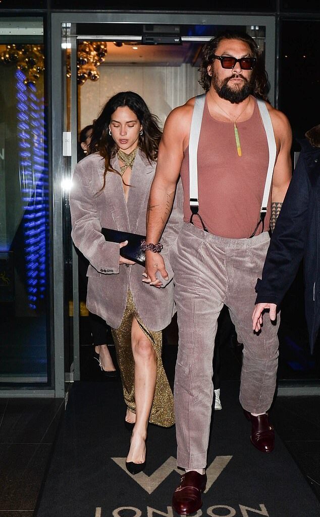 Jason Momoa proved he was ever the gentleman when he gave his jacket to his girlfriend Adria Arjon as they left their hotel in London on Thursday