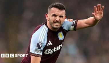 John McGinn signals he is injured during an Aston Villa match