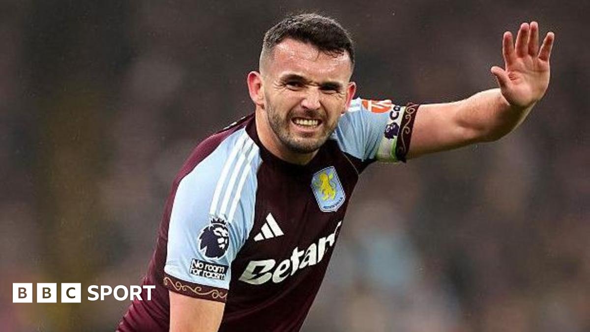 John McGinn signals he is injured during an Aston Villa match