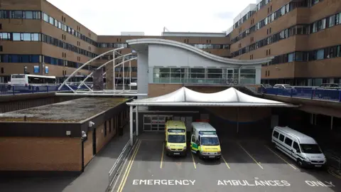 Getty Images Queens Medical Centre (QMC) a light brick building with ambulances parked out the front