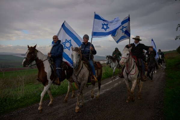 Israelis gather on horseback for the funeral procession of Aviv Maor, an 18-year-old Israeli who was killed by a Palestinian attacker the previous week, at the Kibbutz Ein Harod cemetery in northern Israel, Dec. 29, 2025. (AP Photo/Ohad Zwigenberg, File)