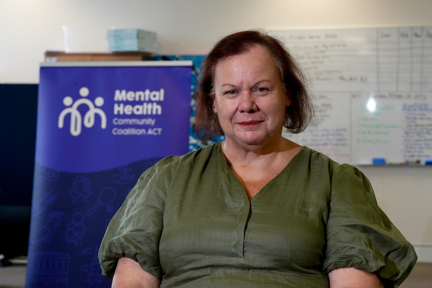 A woman sits in a community mental health office.