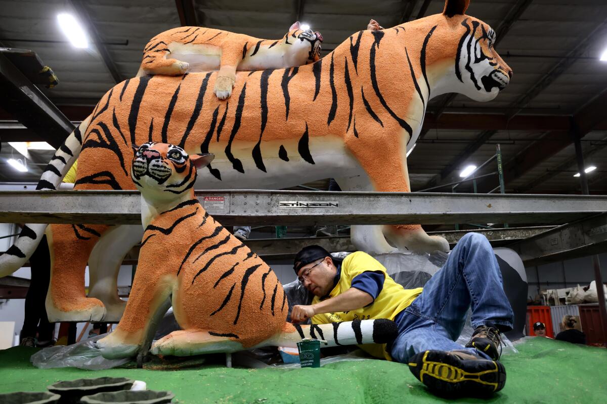 Volunteer Jeff Okayasu, 48, works on the Rotary International float titled, "Unite for Good." 