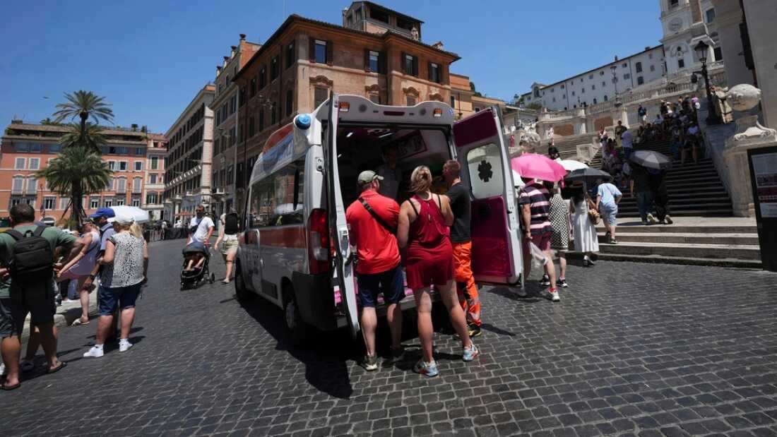 Paramedics provide aid July 1 to tourists and residents with an ambulance next to the historical Spanish Steps in Rome, Italy.