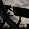 Workers install solar panels at a project this spring in Galena, Alaska.