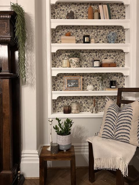 Patterned wallpaper adds depth to shelving units