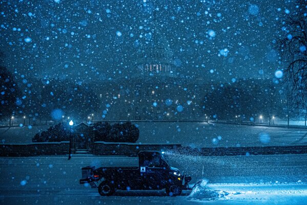 A plow clears snow in front of the U.S. Capitol, Sunday, Jan. 25, 2026, in Washington. (AP Photo/Julia Demaree Nikhinson, File)
