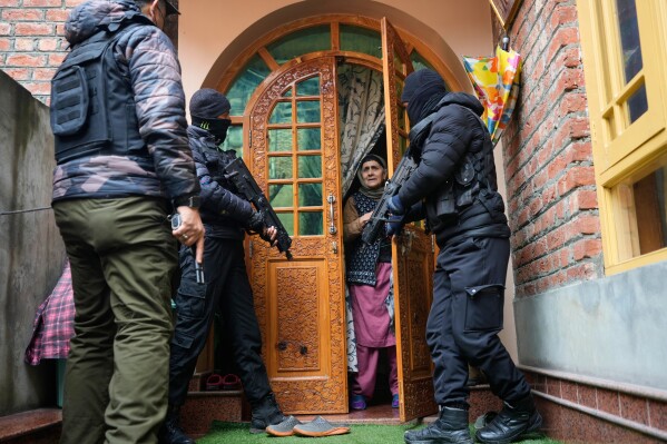 Jammu and Kashmir Special Operation Group (SOG) personnel question local residents during a house-to-house search operation as part of heightened security measures ahead of India's Republic Day in Srinagar, Indian controlled Kashmir, Sunday, Jan. 25, 2026. (AP Photo/Mukhtar Khan, File)