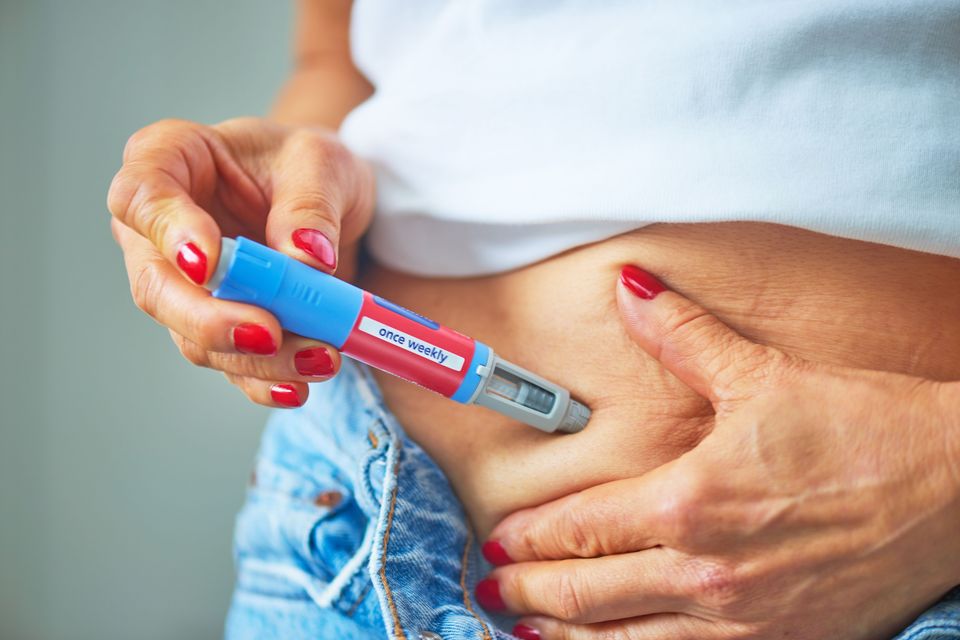 A woman taking an Ozempic injection. Photo: Getty