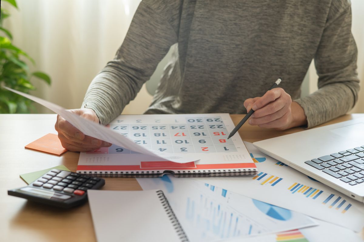 Business Person Looking At Calendar To Check