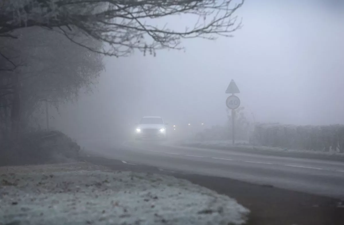 A car negotiates foggy conditions as the temperature stays at -3C during the day on December 11, 2022 in Outwell, England.