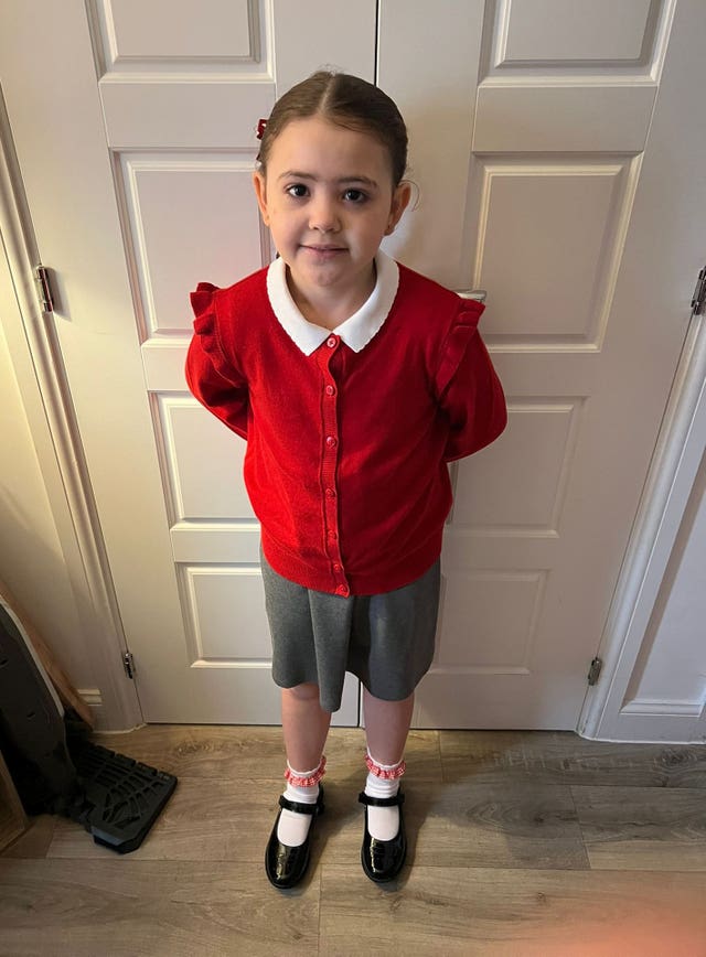 A child in her school uniform 