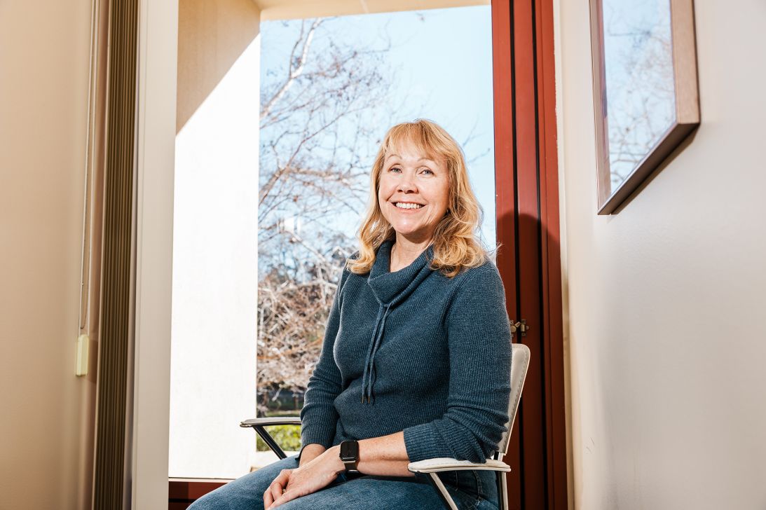 Patient Valerie Zeko poses in a hallway at the Brain Stimulation Lab.