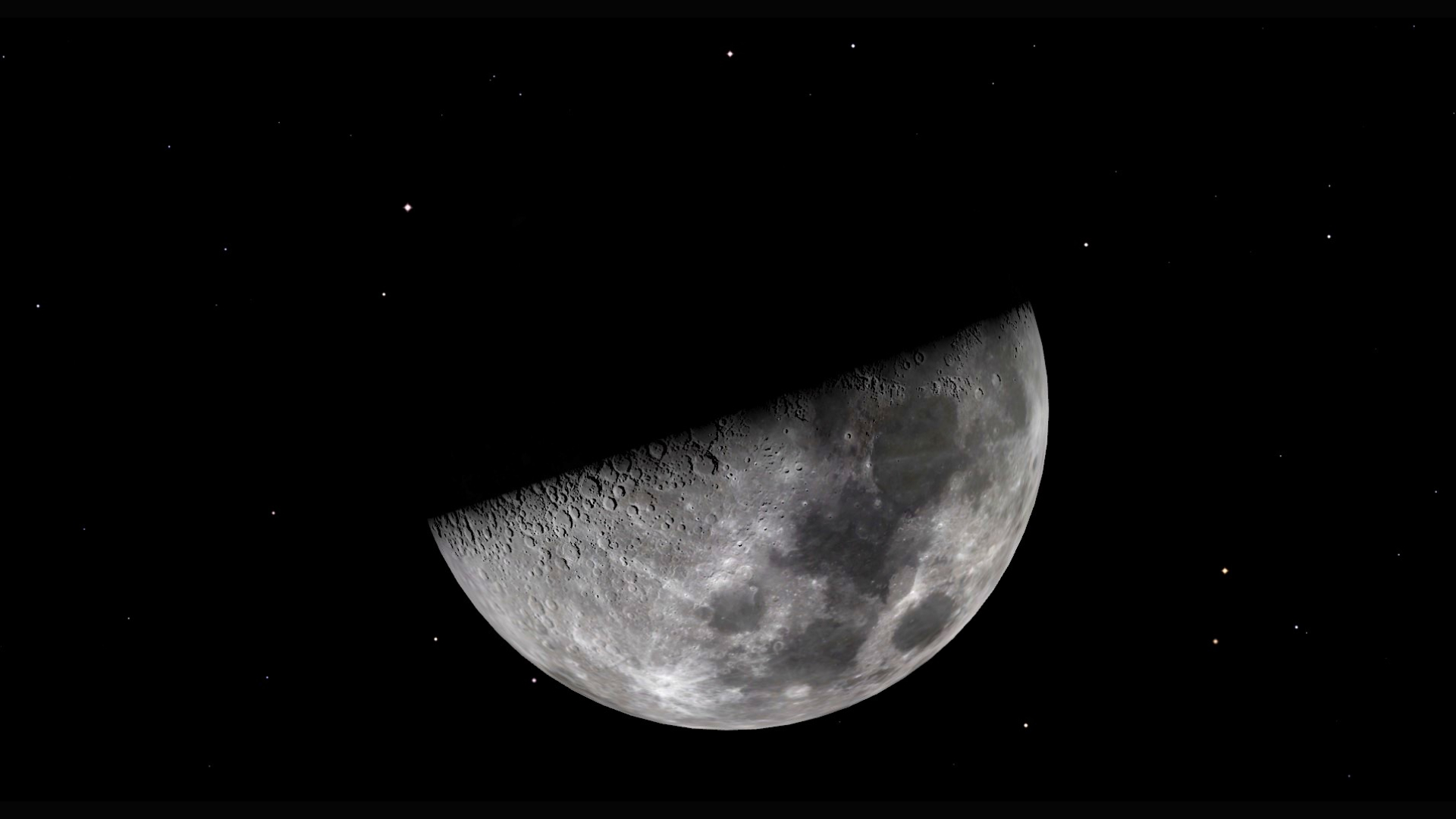A close up of the moon in space, its dark maria obvious. Its top half is in shadow as it is bisected from bottom left to top right