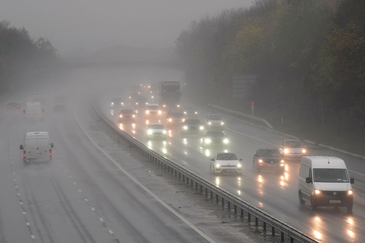 Motorists travel through rain and spray on a motorway (file photo)