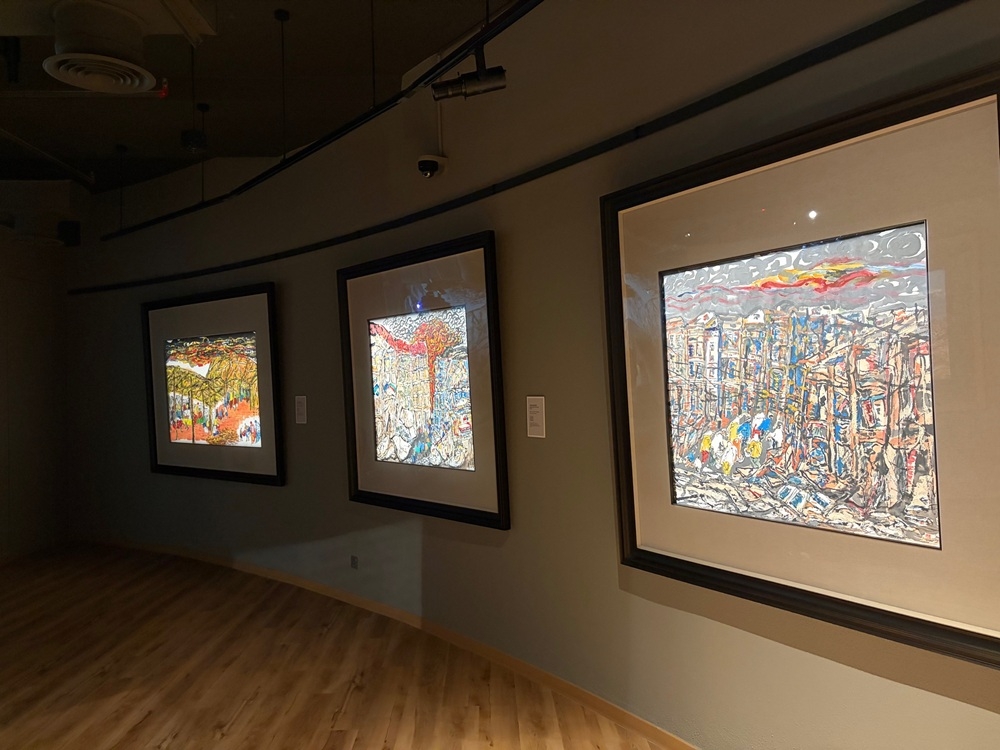 Professor Lin Xiang Xiong’s paintings depicting wars and suffering. Picture by Opalyn Mok