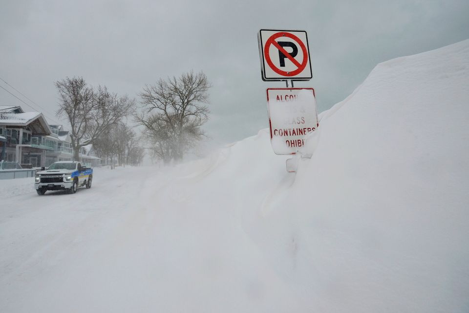 Snow drifts cover no parking signs along Lake Street in St. Joseph, Mich., on Monday, Jan. 26, 2026 after a winter storm dumped several inches of snow. (Don Campbell/The Herald-Palladium via AP)