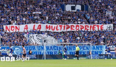 Strasbourg's ultras hold up a banner in protest at the club being part of a multi-club ownership structure