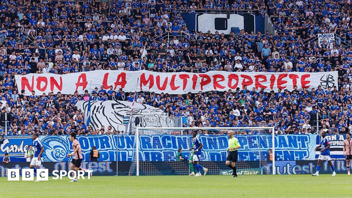 Strasbourg's ultras hold up a banner in protest at the club being part of a multi-club ownership structure
