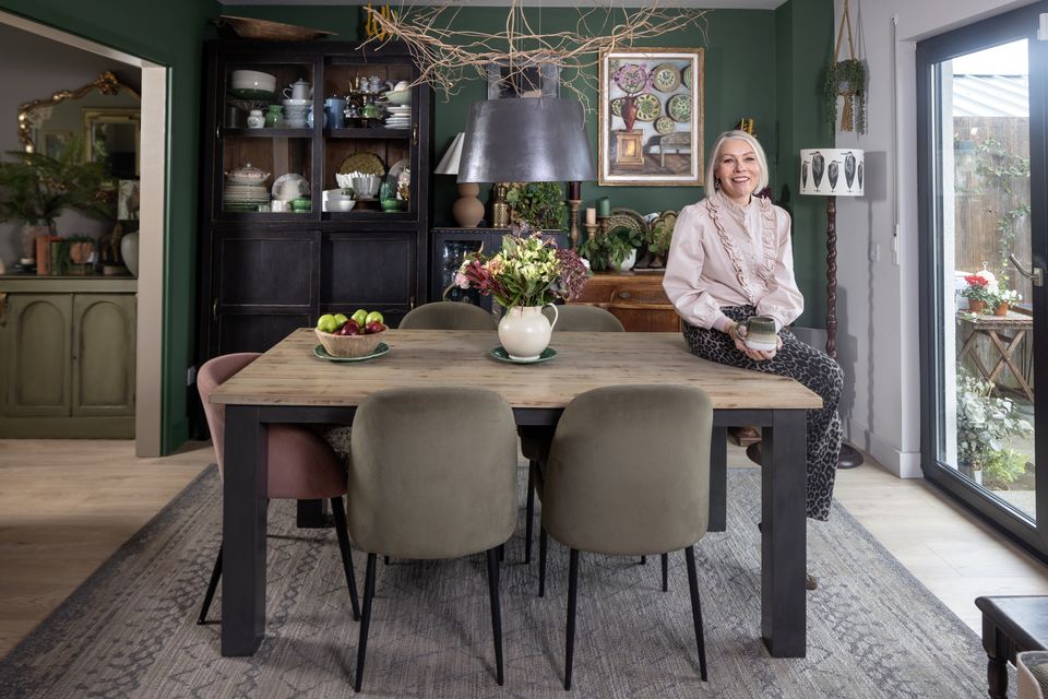 Interiors stylist Sarah Twigg Doyle in the dining area of her home which is about 20 years old but which she has managed to fill with character and soul through a mix of upcycled items, plants and paintings by her husband Gavin, who has recently become a full-time painter. Photo: Tony Gavin