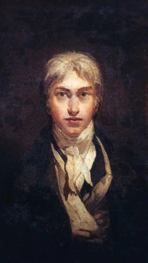 Getty Images Joseph Mallord William Turner oil painting - 'Self portrait, age 24'. A man with blonde hair sits in a dark room, he is wearing a lace cloth and a navy jacket.