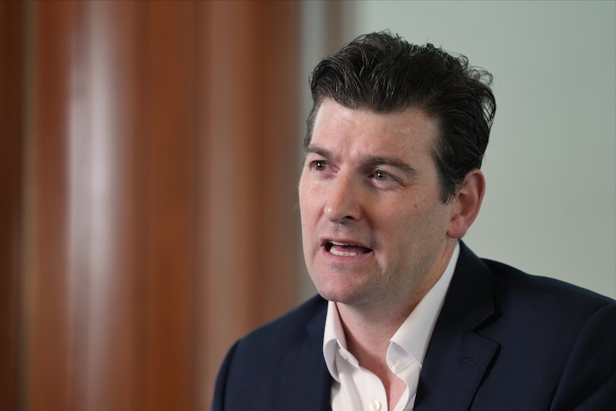 A side angle of a man speaking