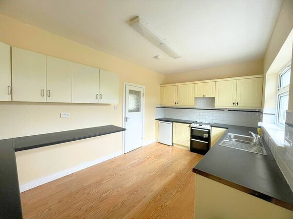 The kitchen area is bright with plenty of space.