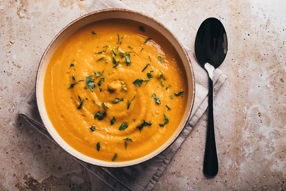 Top view of pumpkin soup on brown background