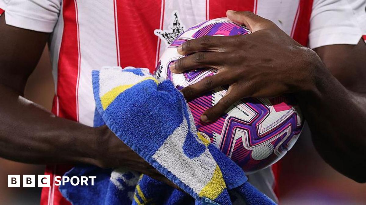 A close-up of Brentford's Michael Kayode drying the ball with a towel