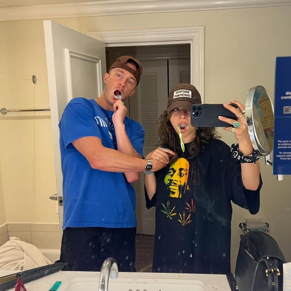 selfie taken in a bathroom with two individuals