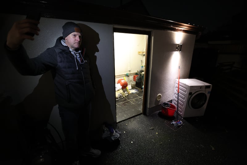 Keating showing water levels and destroyed equipment at his home in Kilternan.  
