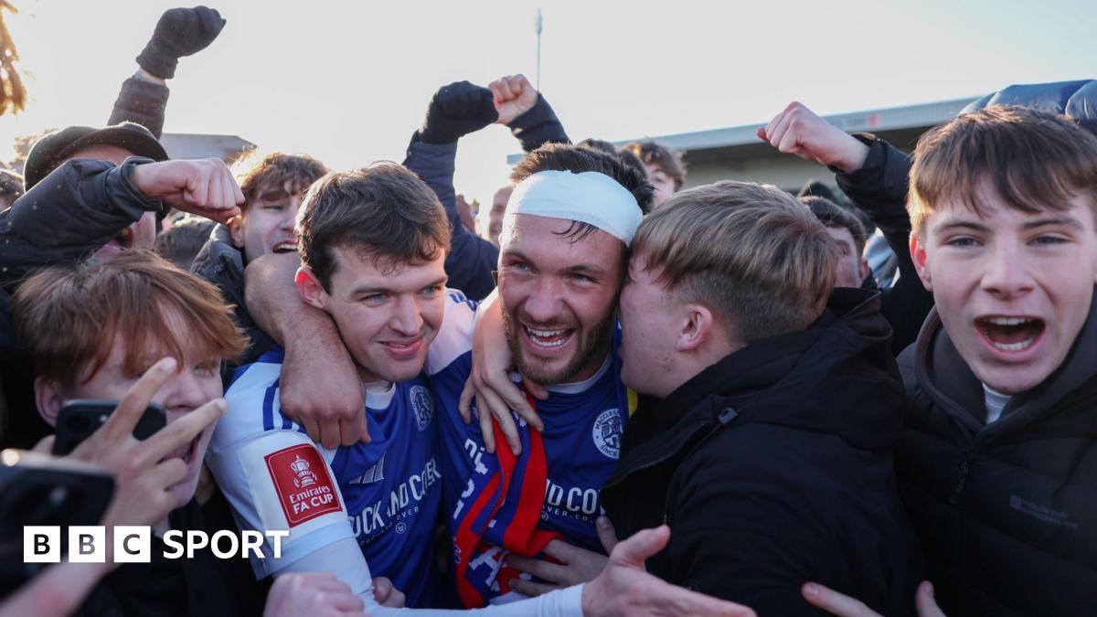 Paul Dawson of Macclesfield celebrates with team-mate Luke Duffy and fans after the team's victory over Crystal Palace