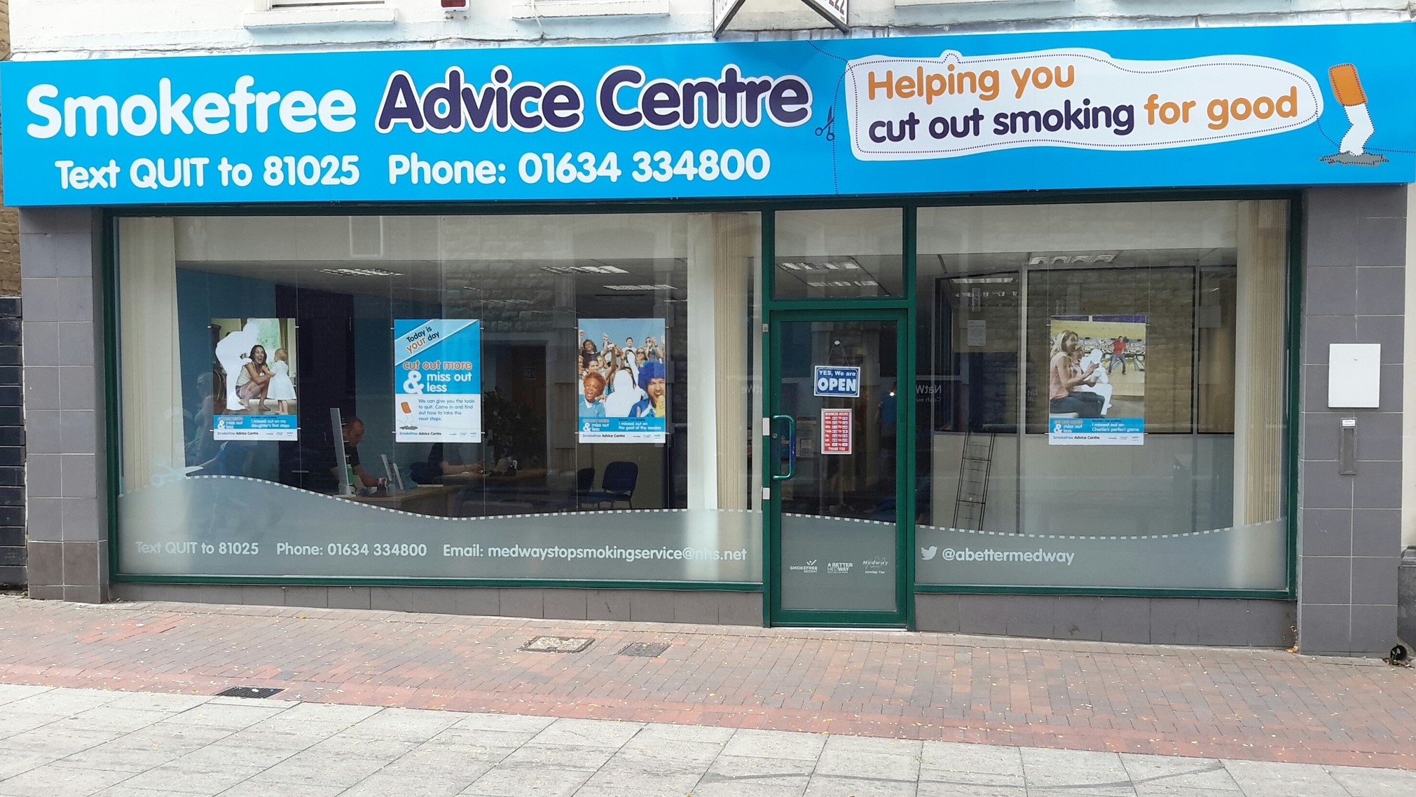 A picture of the Chatham Stop Smoking Shop - you can see posted in the window, and an sign saying we are open on the door. A light blue sign runs across the top of the windows and door and reads: "Smokefree Advice Centre".