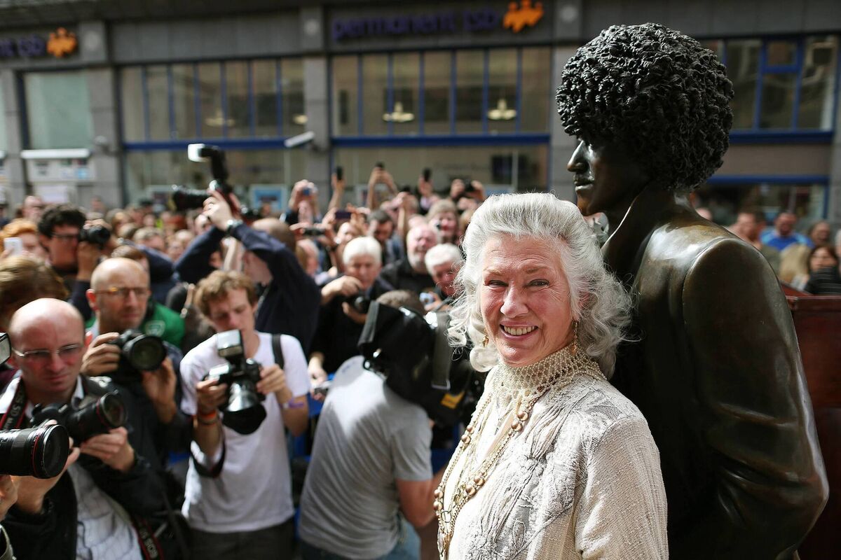  Phil Lynott's mother Philomena Lynott is surrounded by press photographers at the unveiling of the repaired statue of the Thin Lizzy frontman on Harry St off Grafton St, Dublin in 2013. Picture: Julien Behal/PA