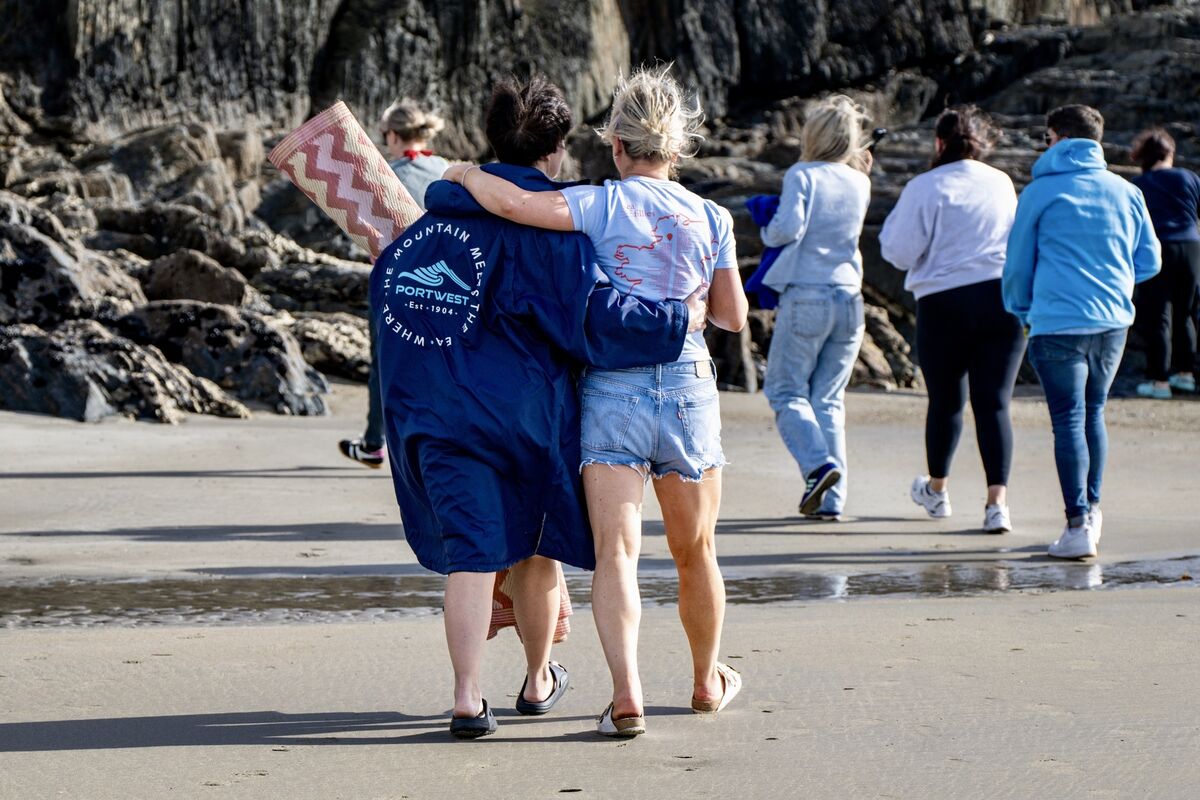 Biddy Hughes and Orla Leahy walk arm in arm towards the ocean at Inchydoney beach for their final Sea Fillies swim. Pictures: Chani Anderson