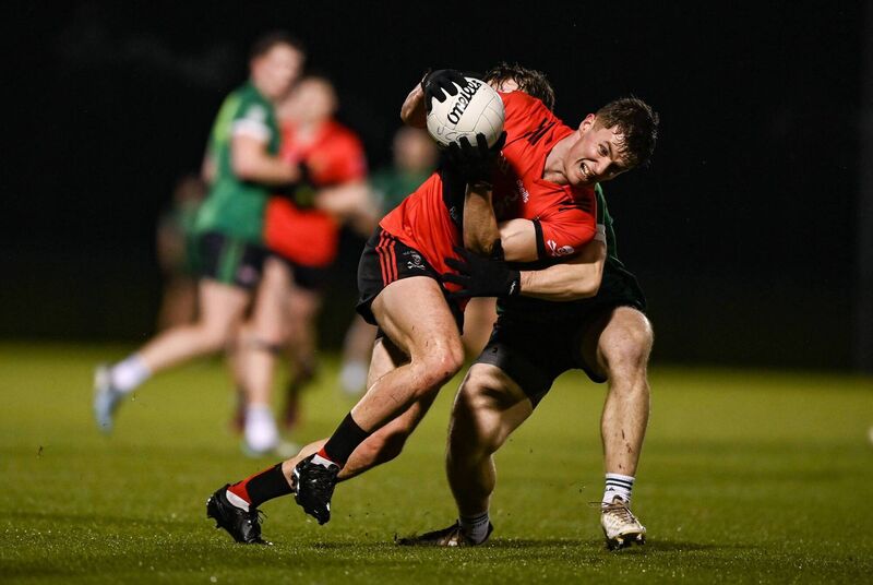 Dan Peet of UCC in action against Ryan McQuillan of Queen's University Belfast. Picture: Tyler Miller/Sportsfile