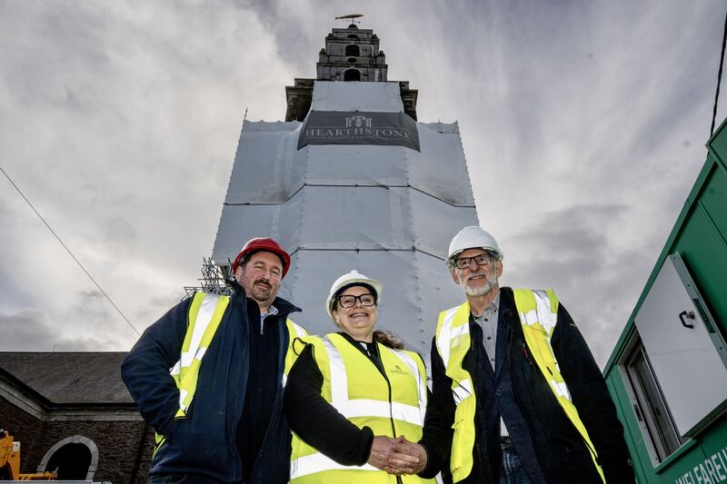 Architect Peter Bourke, Reverend Meghan Farr and Hearthstone MD Keith Starr stand before the scaffolding that now enshrouds Shandon Bell Tower, where Cork’s iconic “four-faced liar” clocks were removed for the first time in decades in October 25. Picture Chani Anderson
