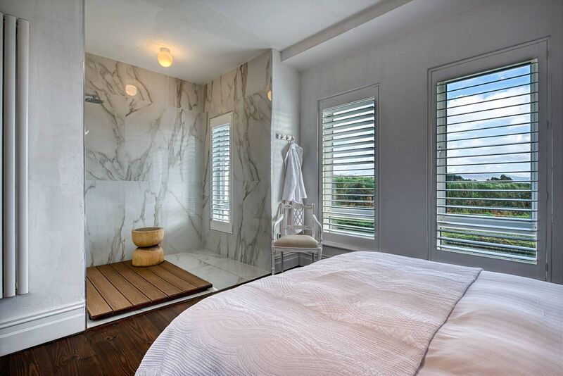 A wall was knocked to create a luxury shower in the main bedroom