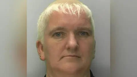 Gloucestershire Constabulary Mug shot of Amanda Wixon. She has short, blonde hair.