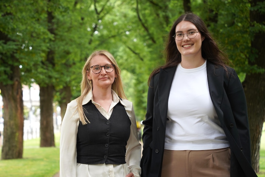 a portrait photo of Dr Knight and Dr Symons standing next to each other in a Melbourne park