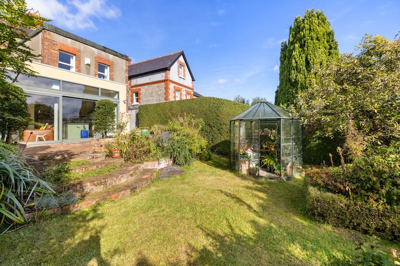 The house has a redbrick patio to the rear