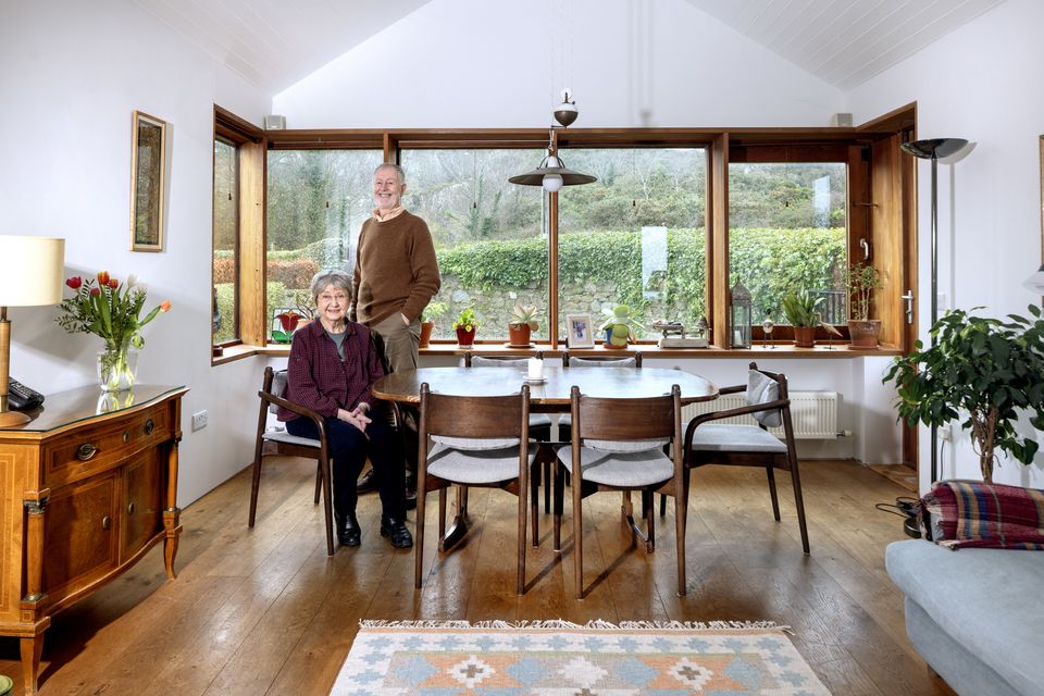 David and Maria Bourke in the living room of their home which their son Robert redesigned. The room originally had a triangular bay window and one of Robert’s innovations was to give it a big rectangular bay window with new views to the garden and to the Dalkey quarry. Photo: Tony Gavin